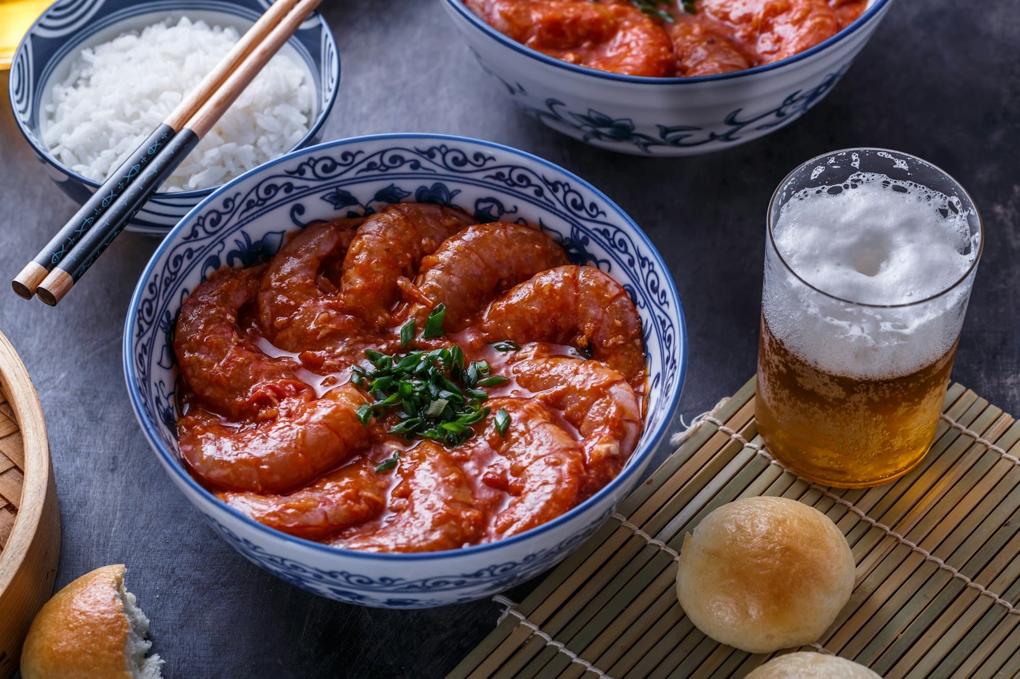 Close view of bowl with big prawn in hot sauce with beer, asian cuisine